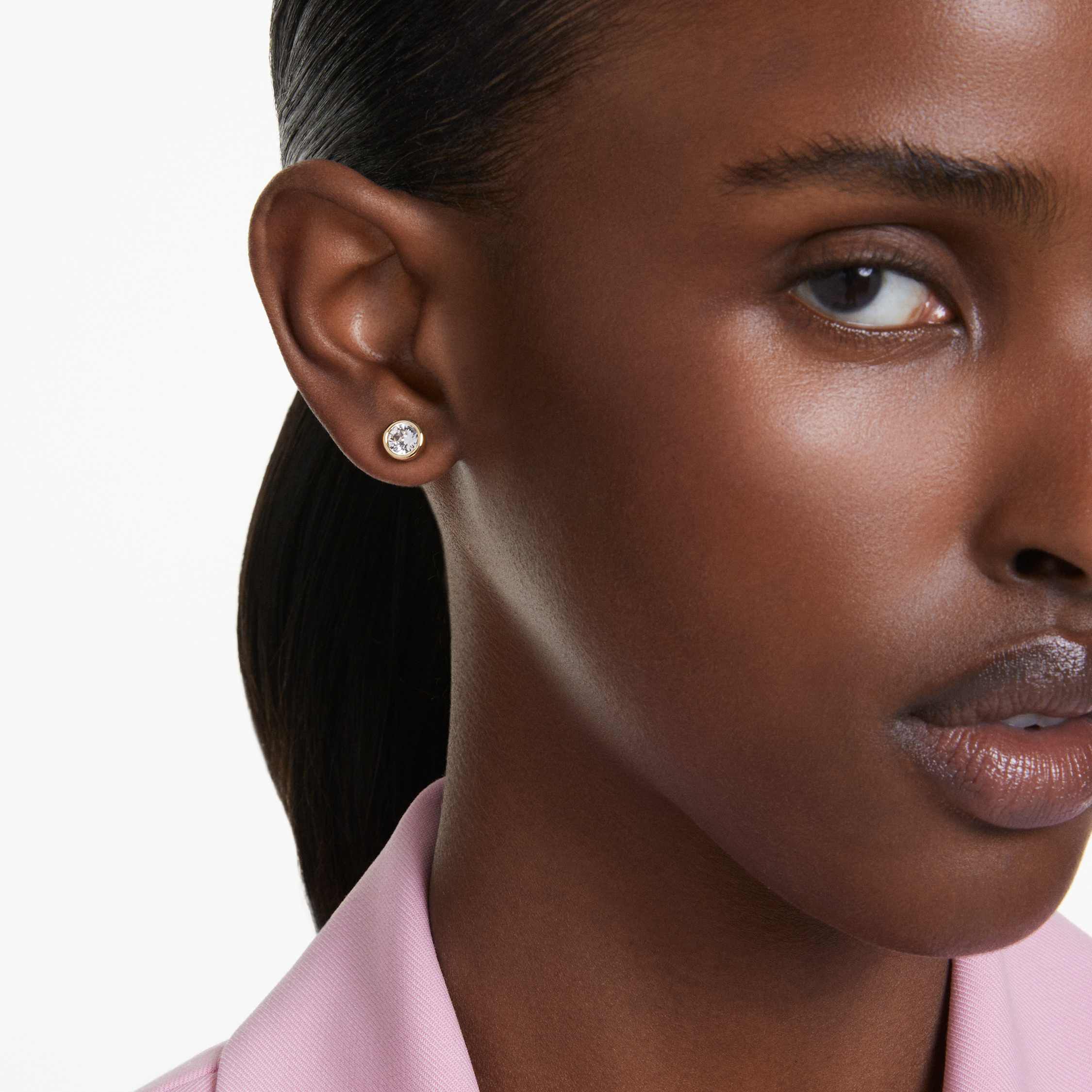 Woman wearing diamond stud earrings top
